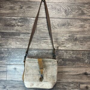 Myra Bag crossbody purse with woven canvas front and leather trim.